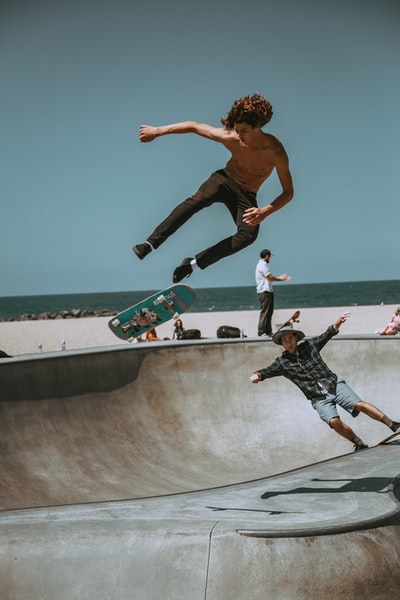 Two men in the bowl of skateboard ramp
